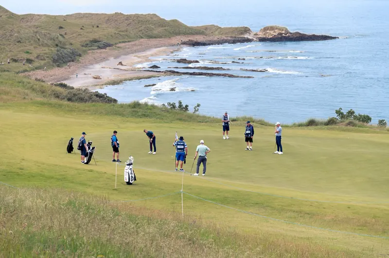 Golfers enjoy a game on a coastal course with stunning ocean views