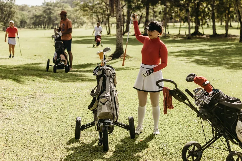 Golfers playing and relaxing on a sunny day at a lush green course